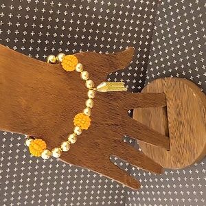 Gold tone stretchy pumpkin seed bead ball tassel bracelet NWOT